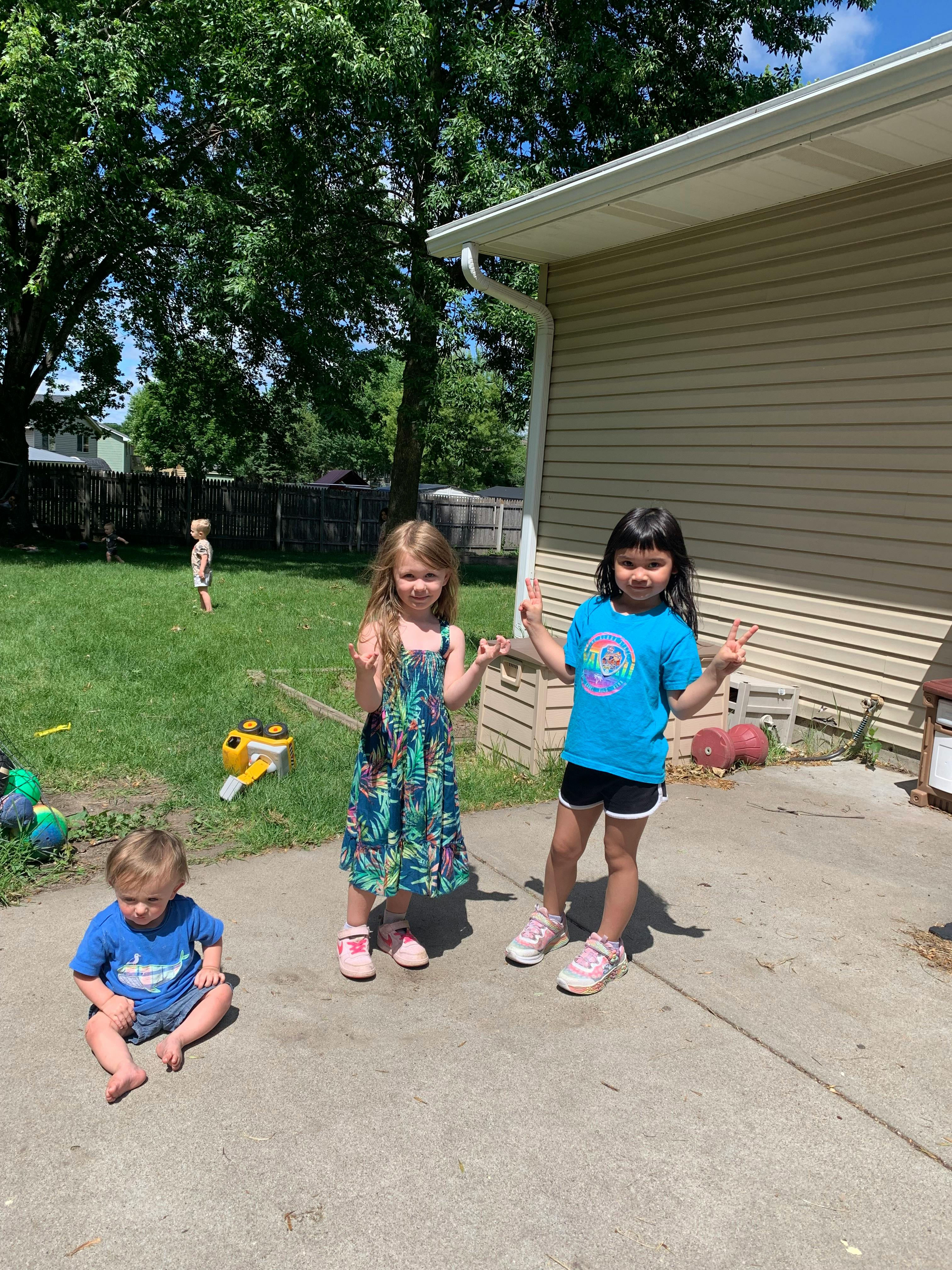 Three children playing on a patio