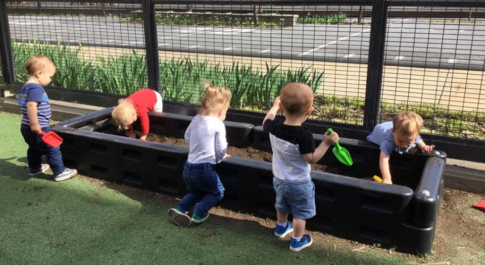Four children playing in a sandbox