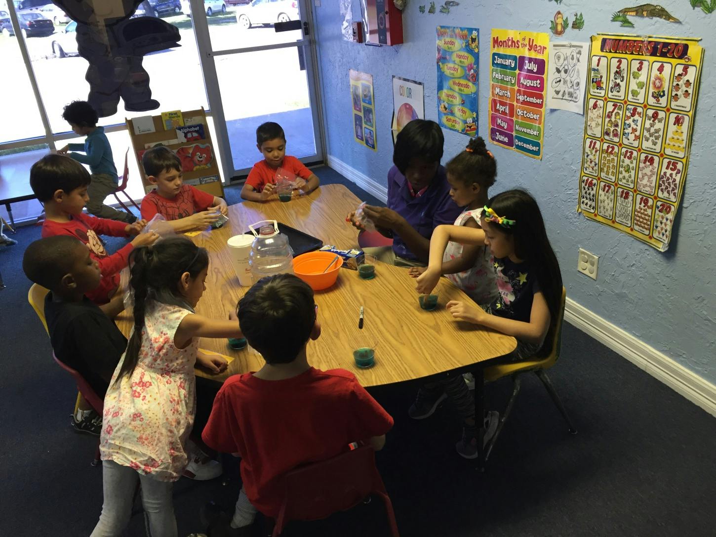 Children sitting around a table in a classroom