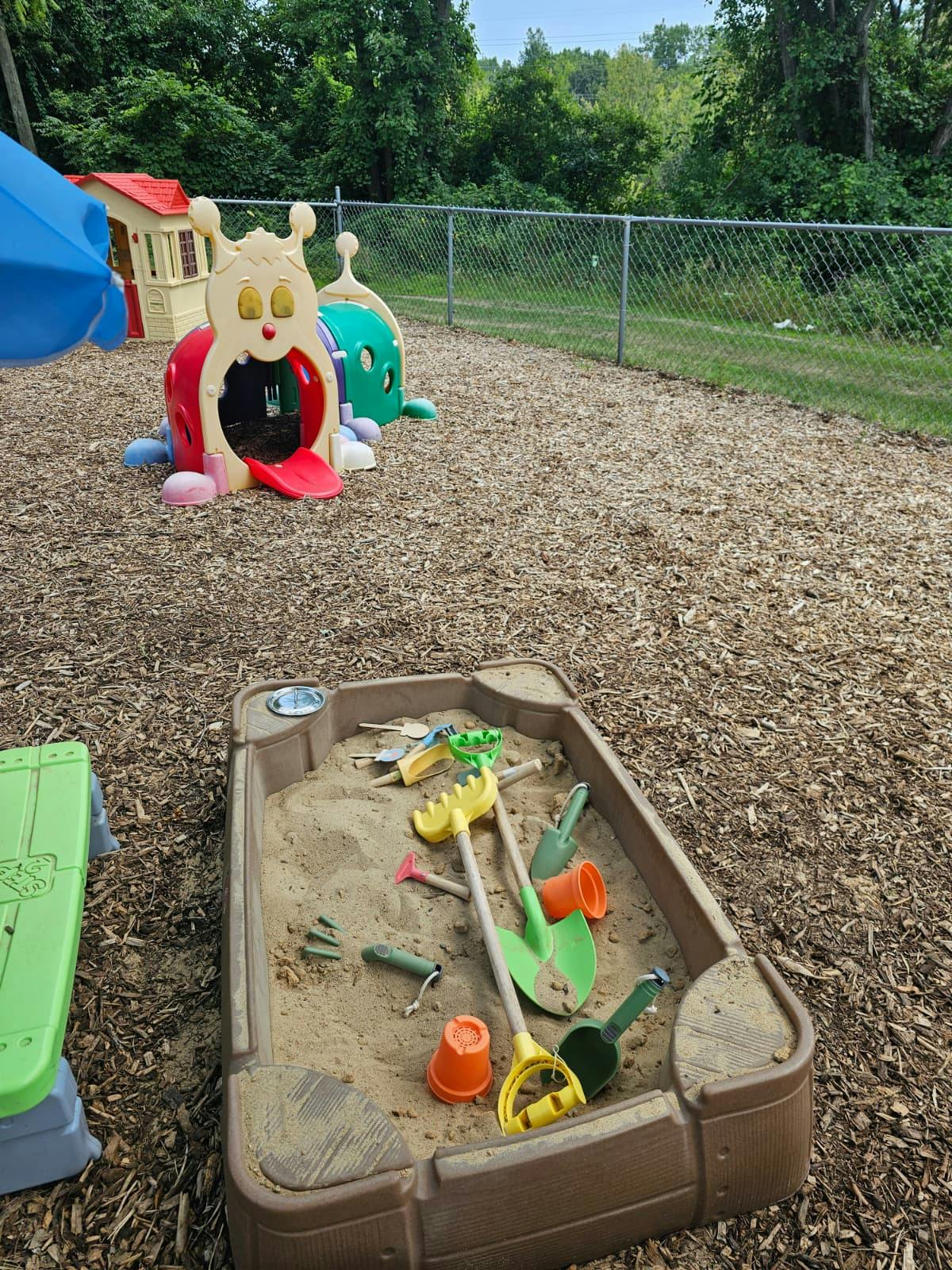 Sandbox with plastic toys in a playground