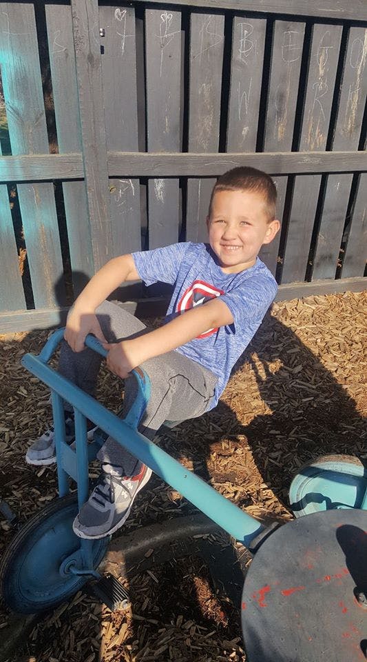 Child on a blue ride-on toy
