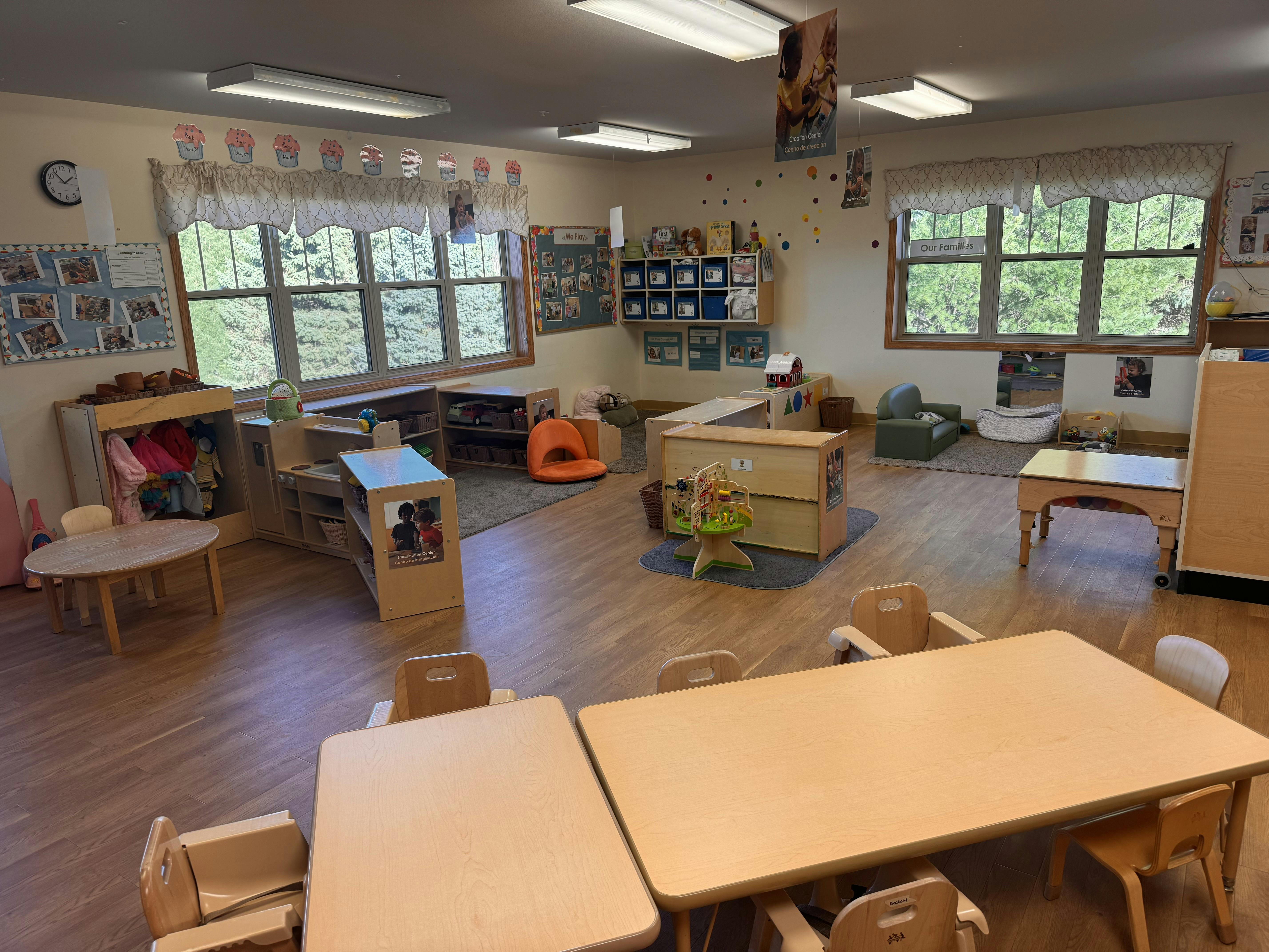 A colorful empty classroom with small tables and chairs