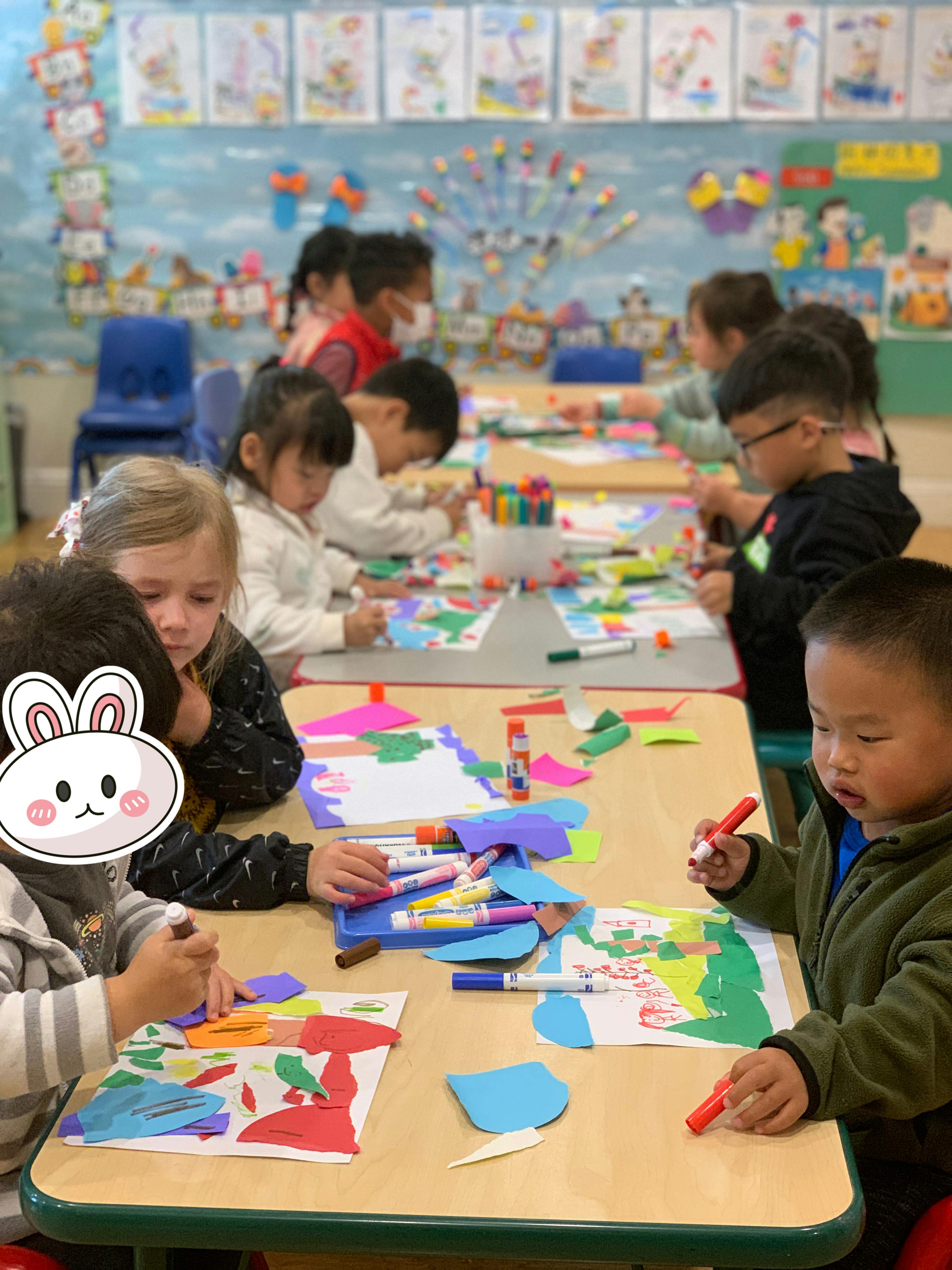 Children doing crafts at tables in a classroom