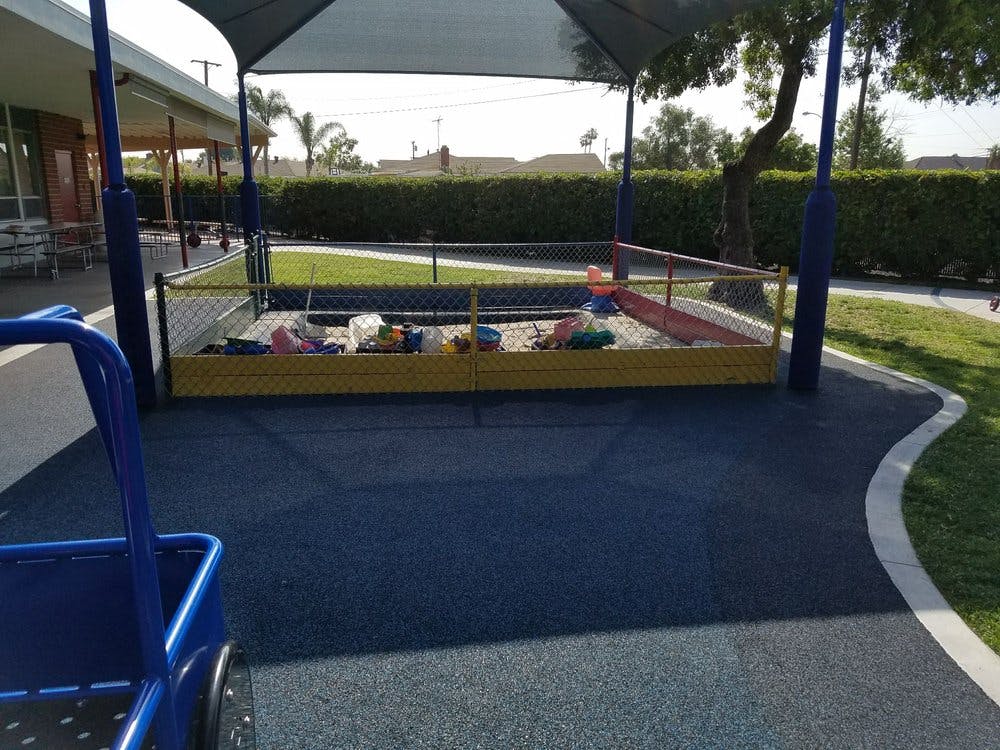 Sandpit with toys under a canopy on a playground