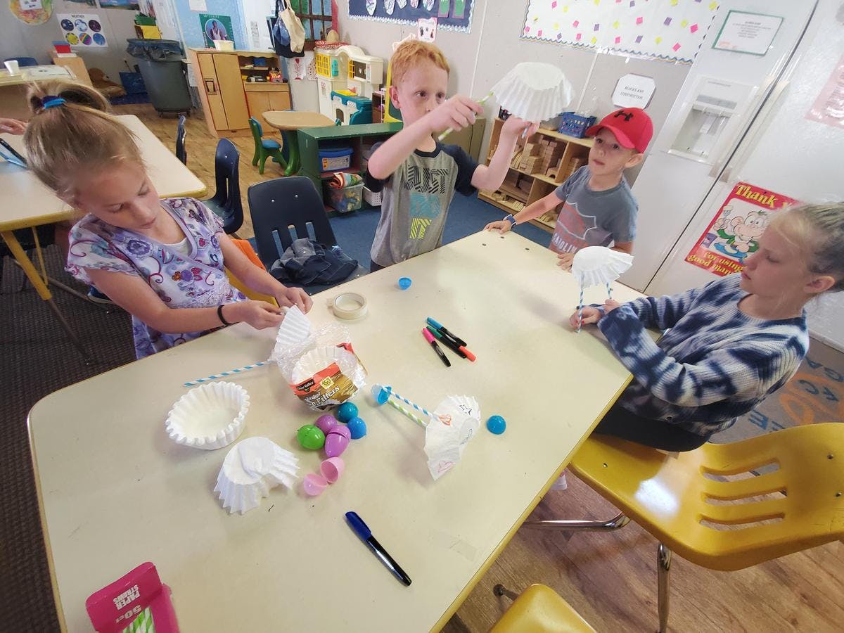 Children at a table with craft supplies