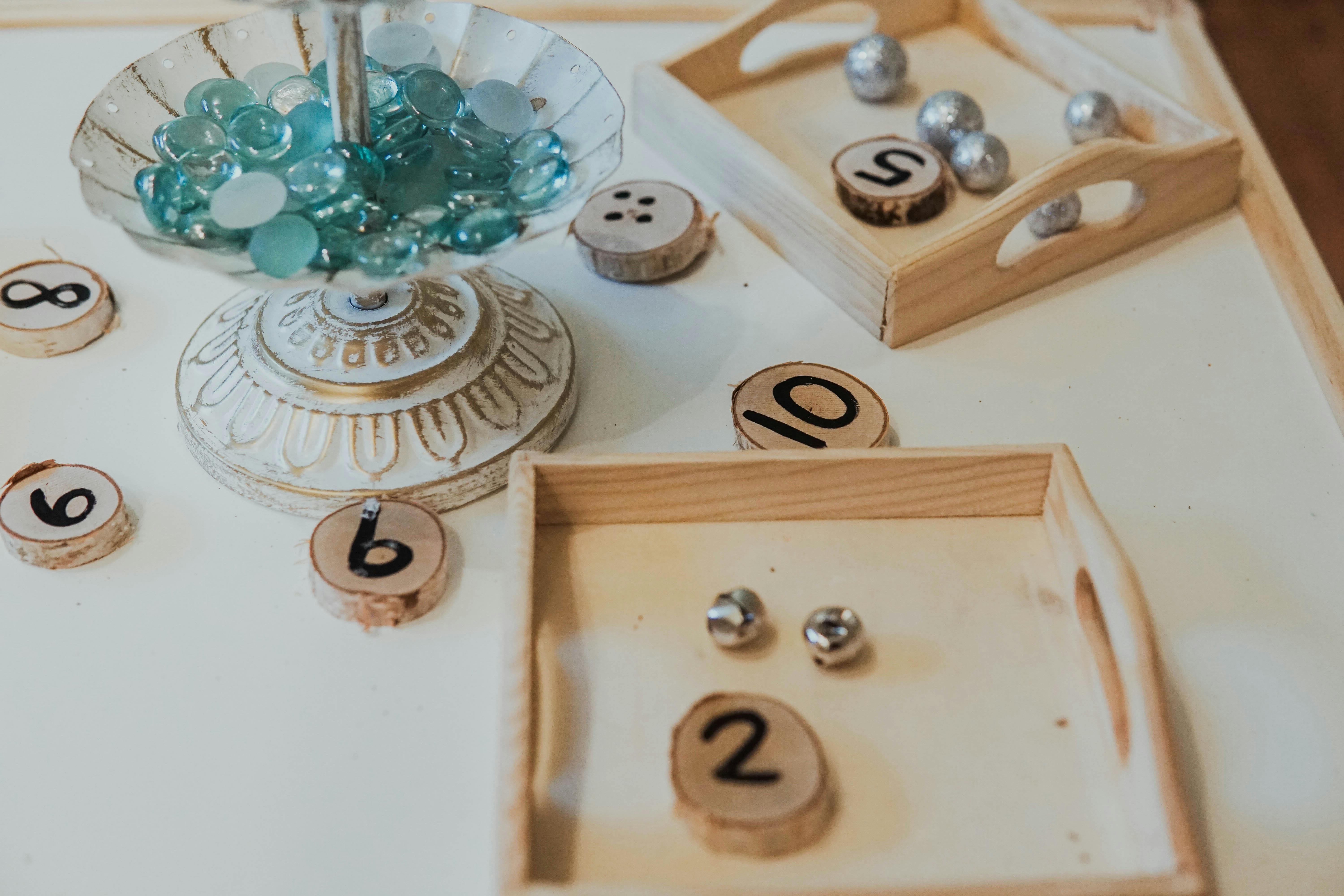 Wooden number discs and small objects on trays