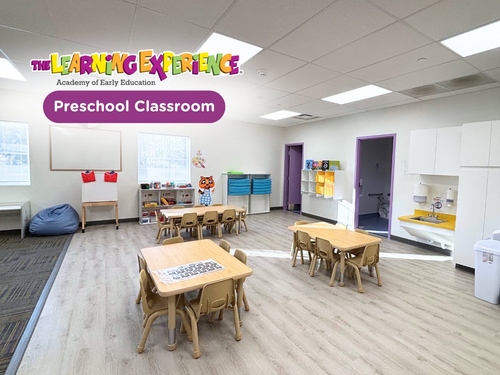 empty preschool classroom with small tables and chairs