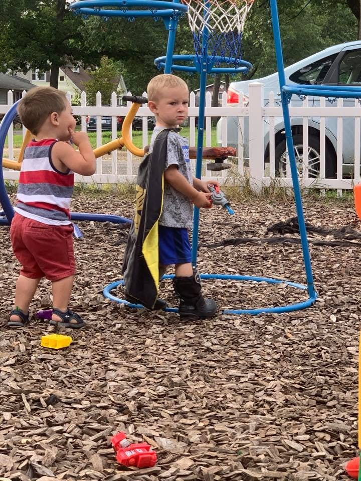 Two children playing on a playground