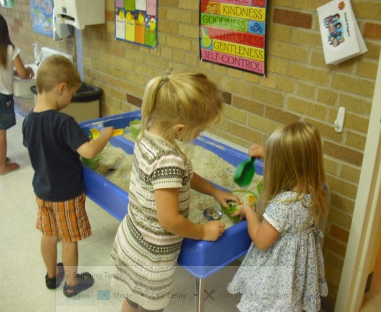 Children playing in a sand table