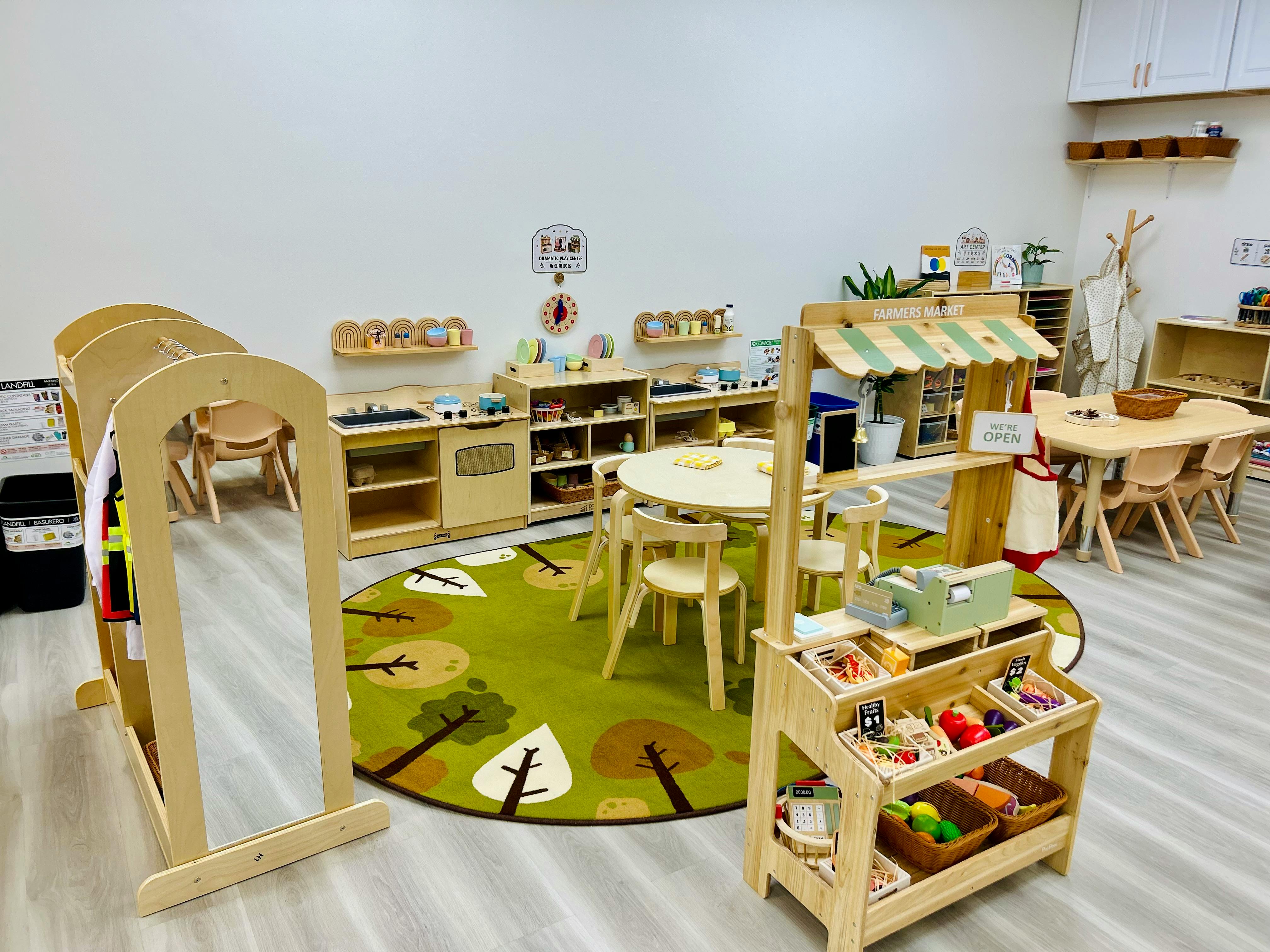Wooden toy furniture and farmers market play stand in a classroom