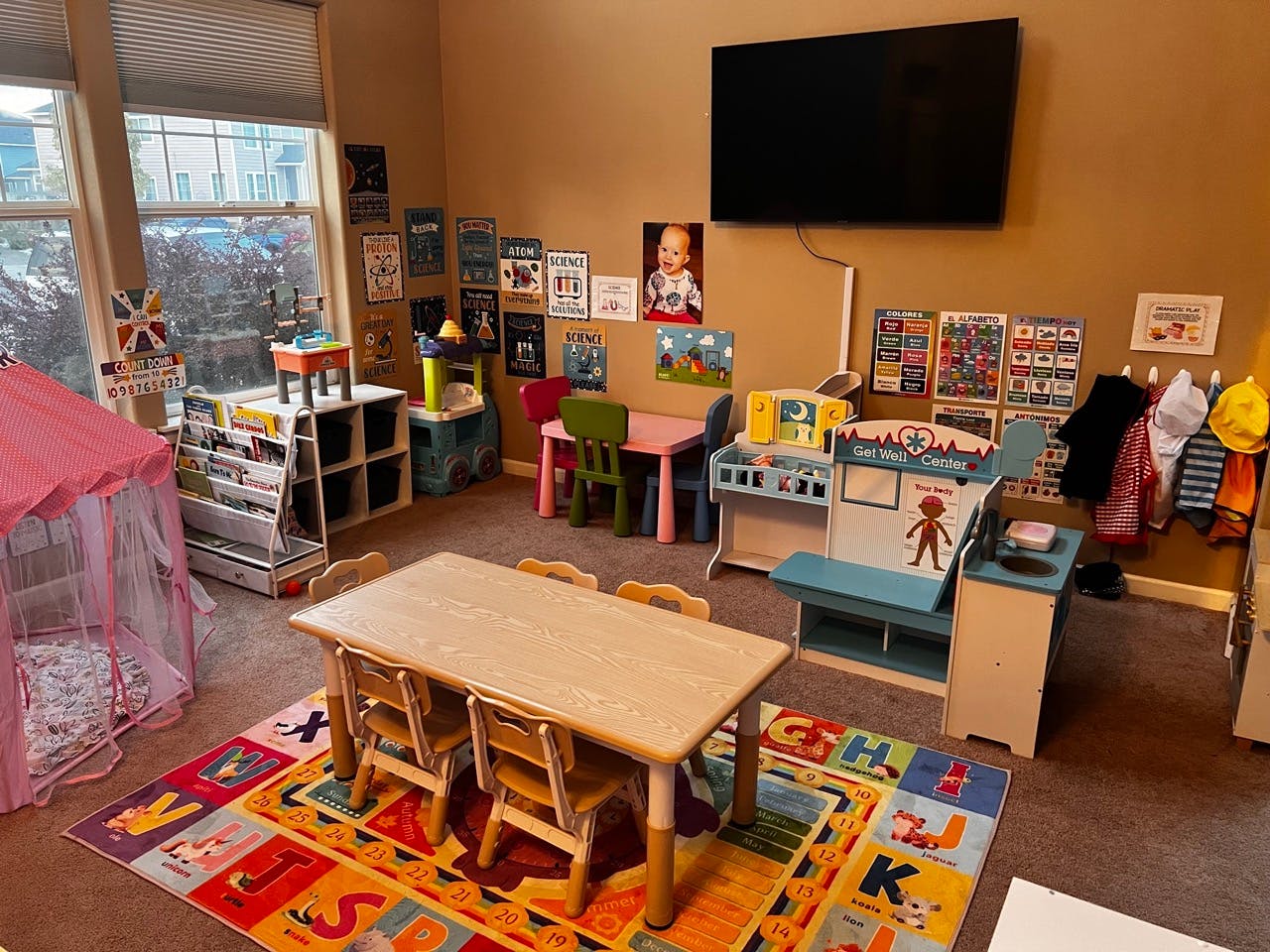 Children's play area with small tables, chairs, and toys