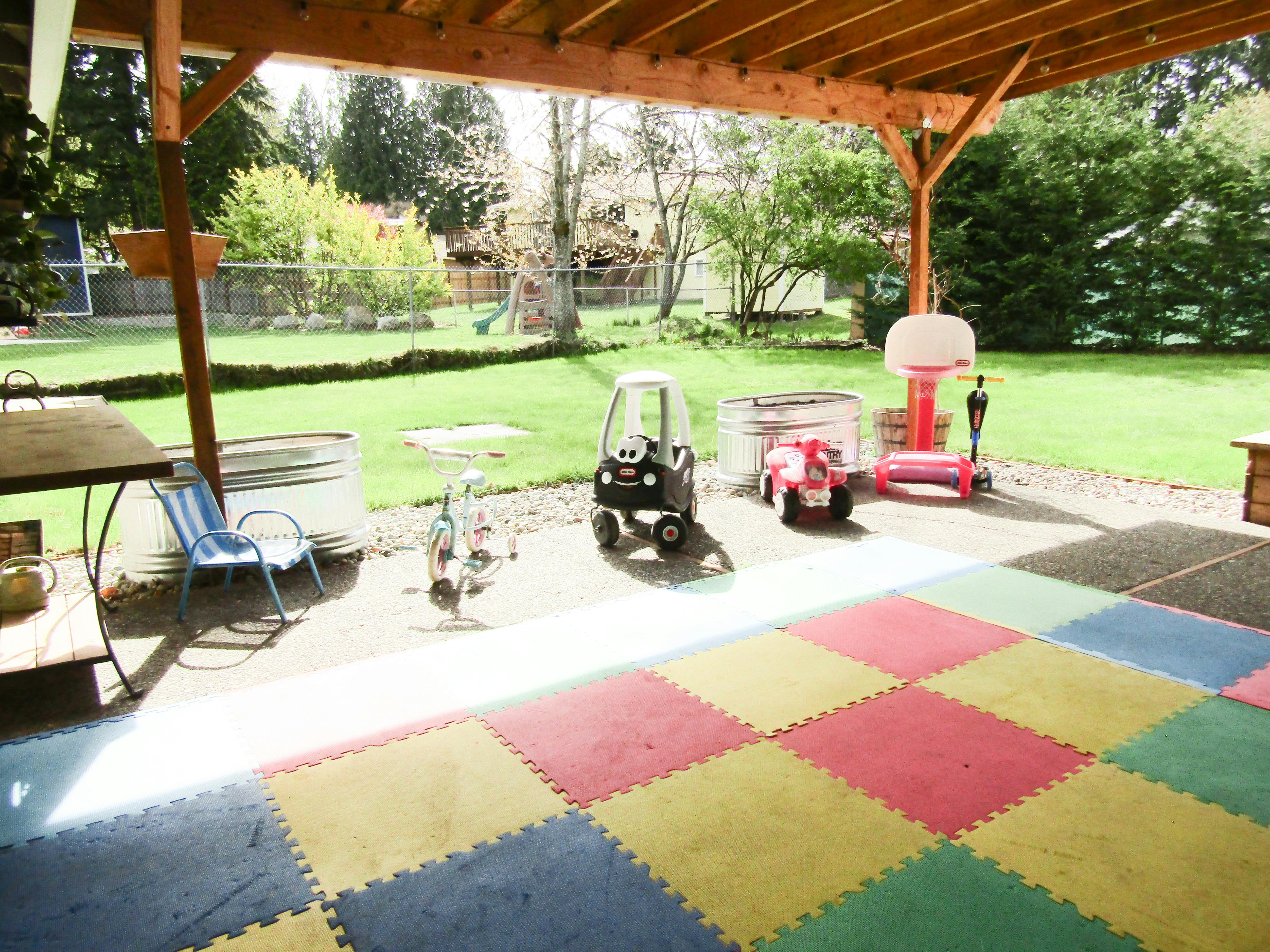 Outdoor patio with colorful play mats and children's toys
