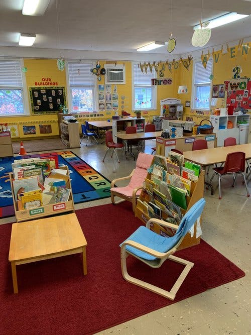 Classroom with tables, chairs, and book displays