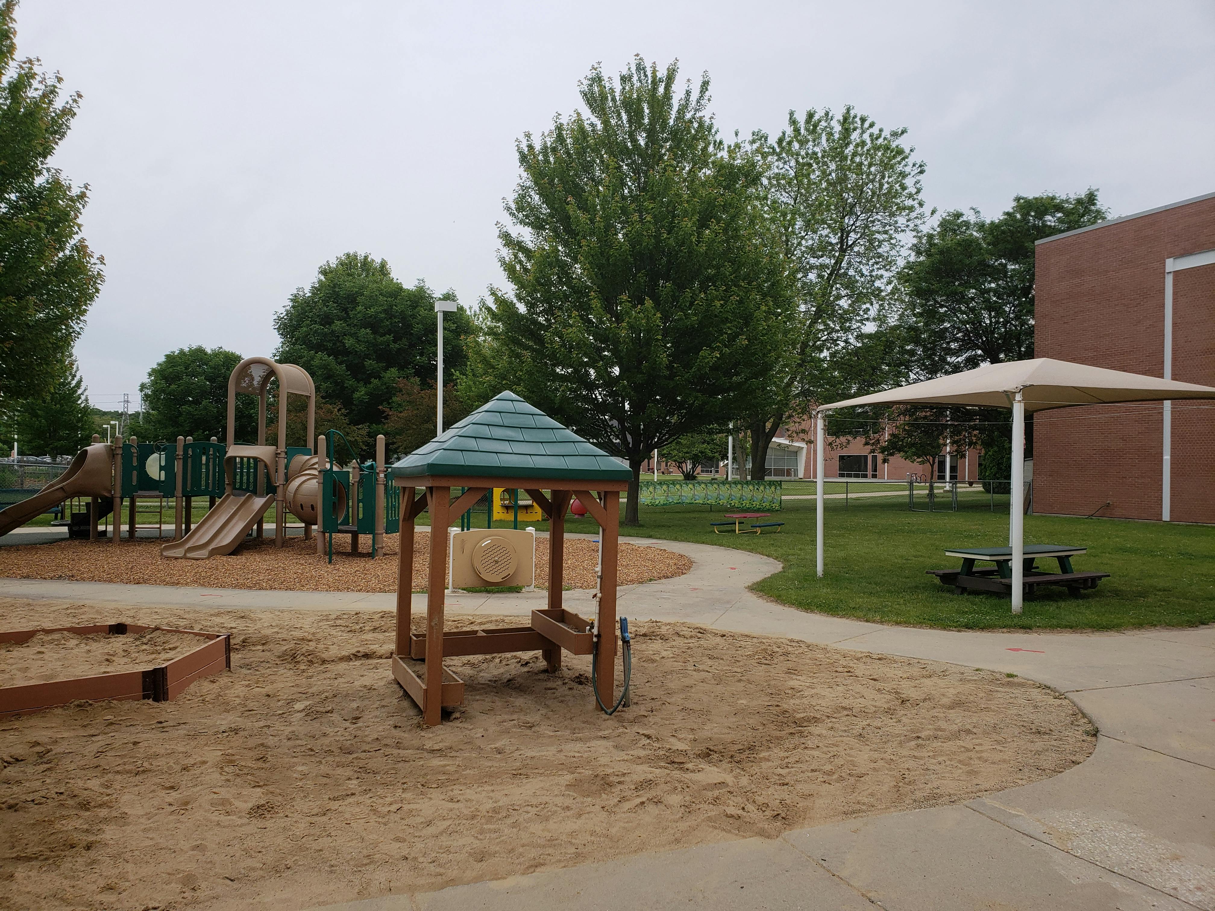 Playground with sandboxes, play structure, and shaded picnic table