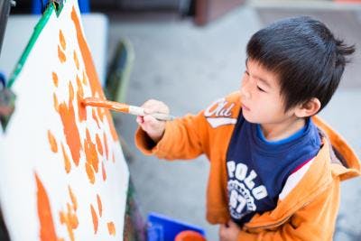 Child painting on an easel