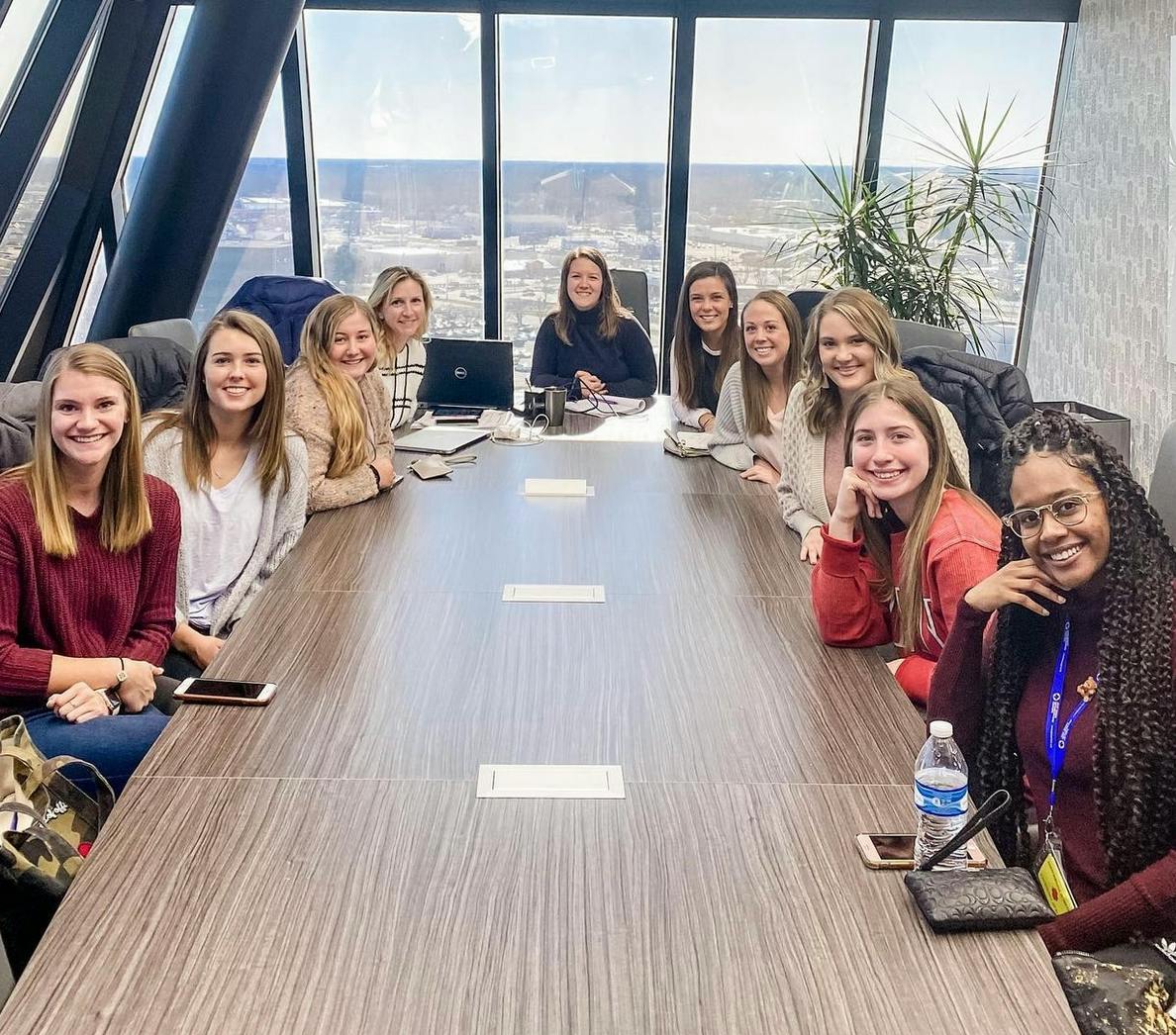 Group of people sitting around a conference table