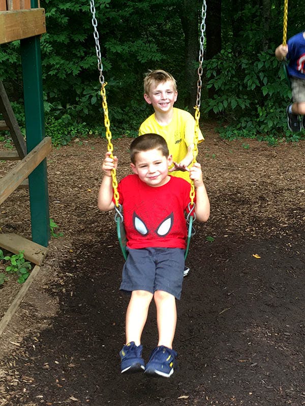 Two children on swings at a playground