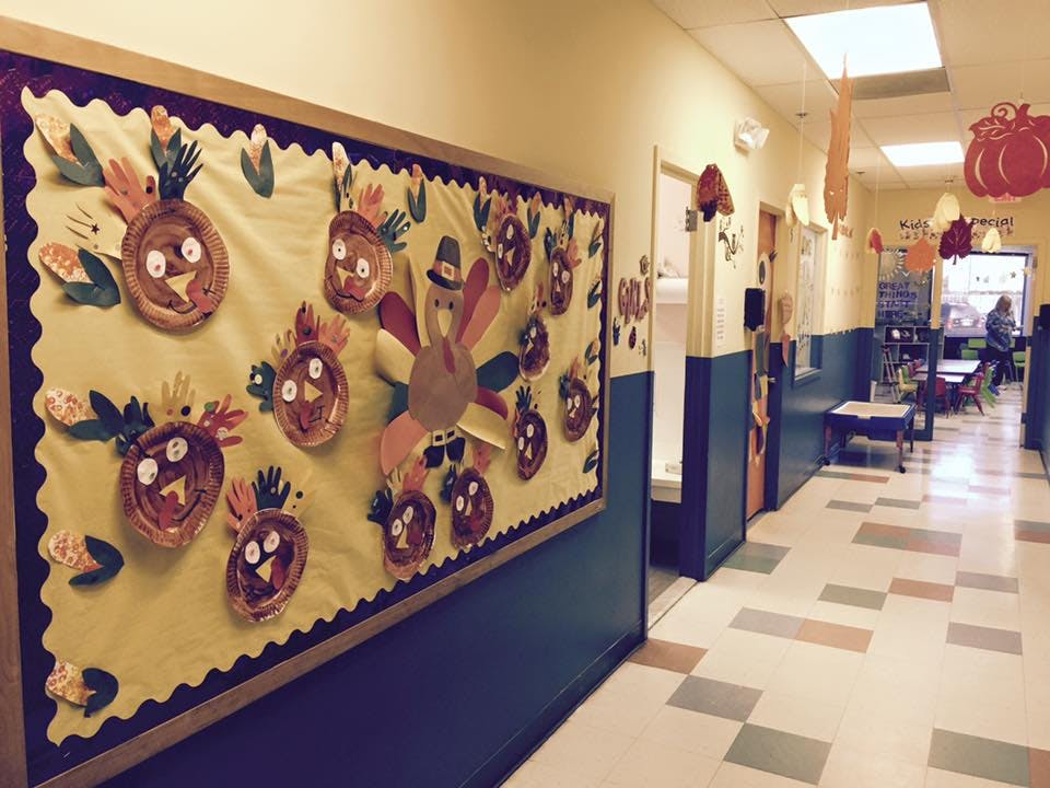 Hallway with a bulletin board displaying turkey and pumpkin decorations