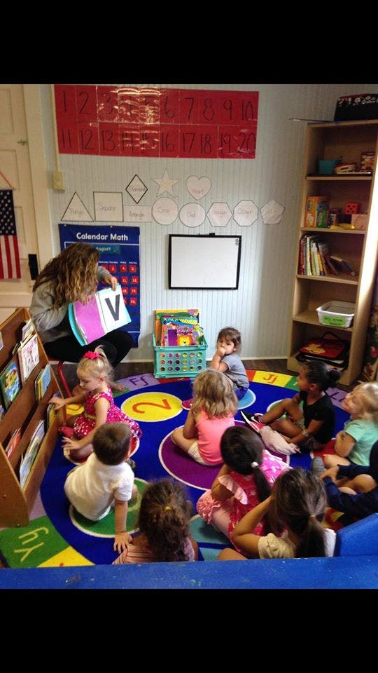 Person teaching children in a classroom