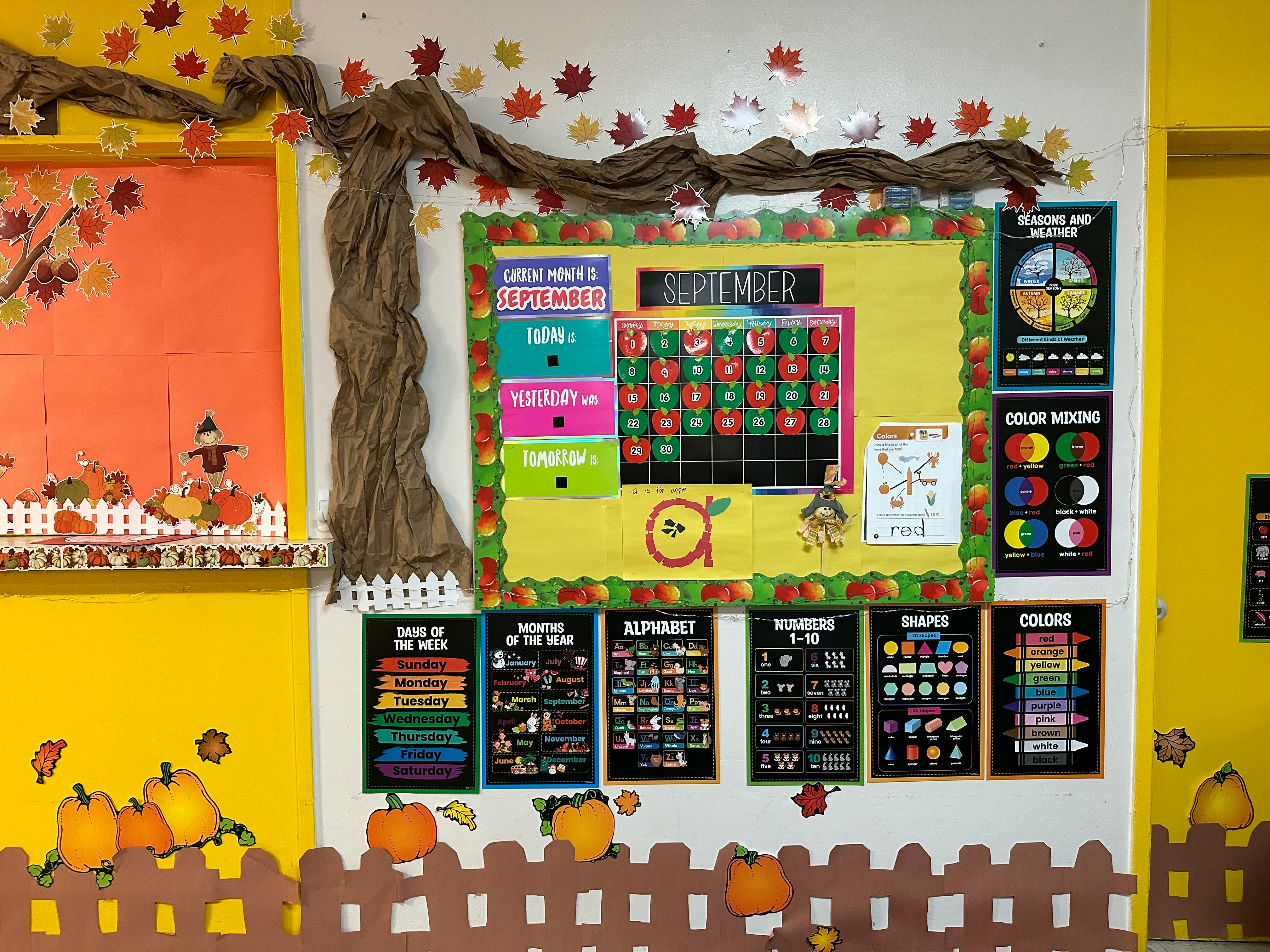 Classroom bulletin board with September calendar and learning charts