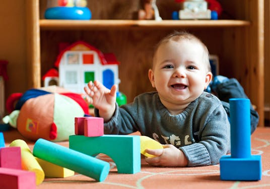 Child playing with colorful building blocks