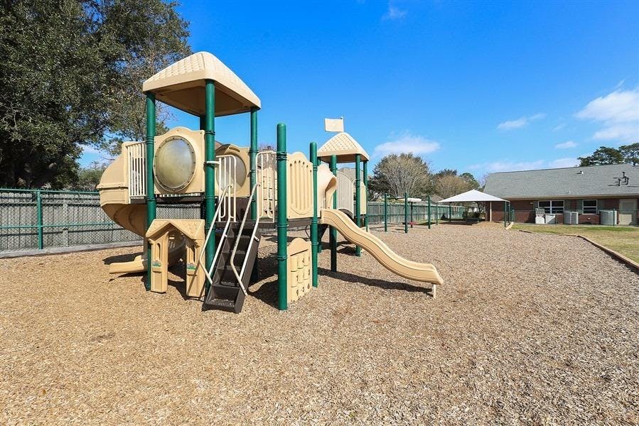 Playground with slides and climbing structures on wood chips