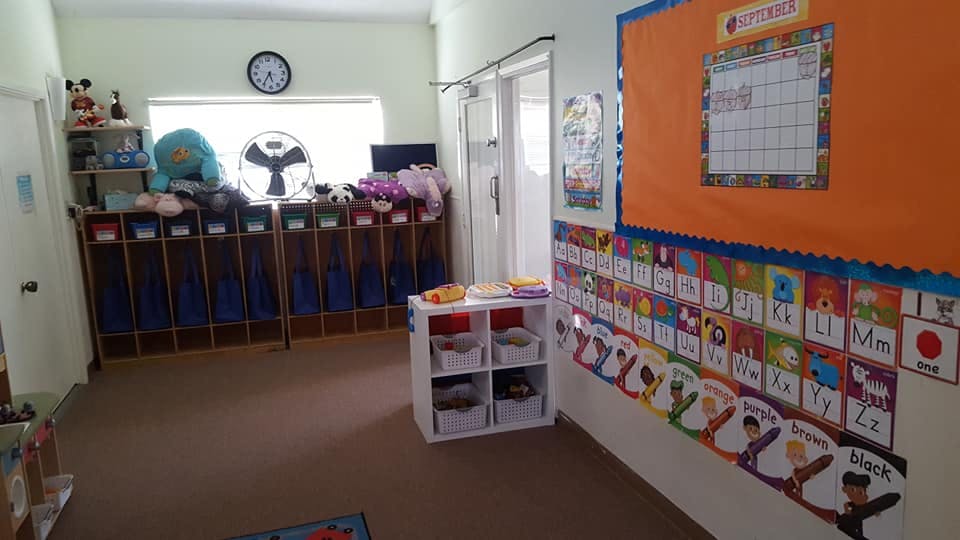 Classroom with cubbies, calendar, and alphabet chart