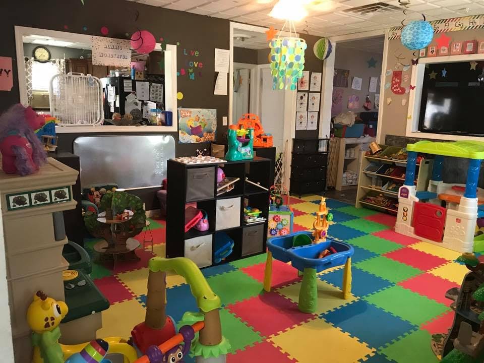 Playroom with colorful interlocking floor mats and various toys