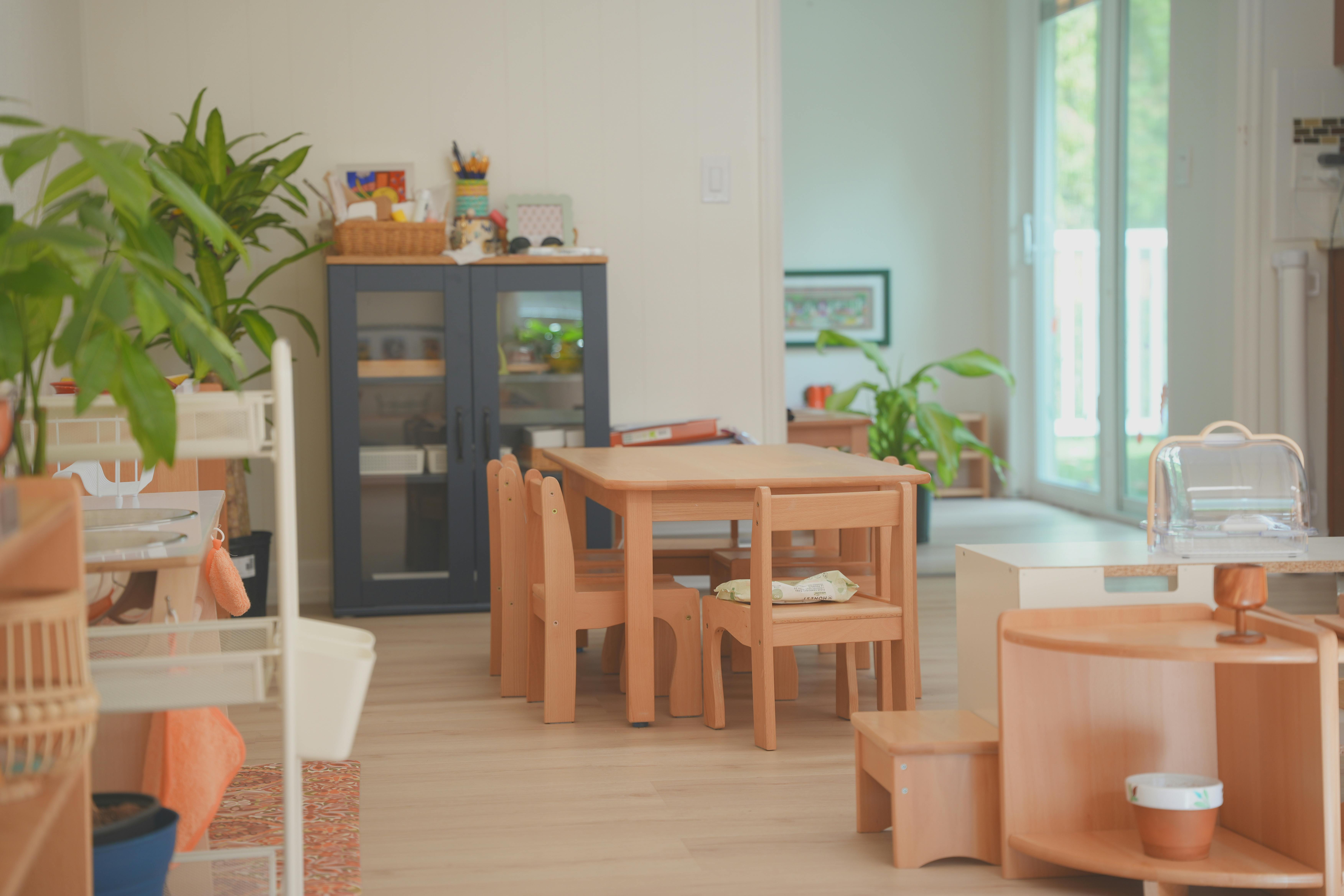 Children's classroom with small wooden tables and chairs