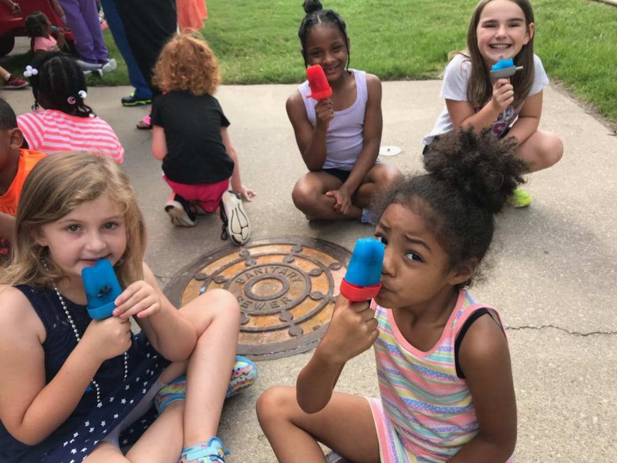 Children eating popsicles outdoors