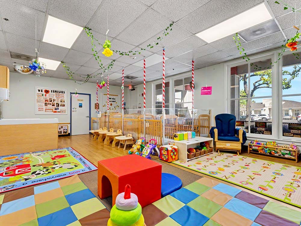 Baby room or nursery with cribs, playmats, and toys