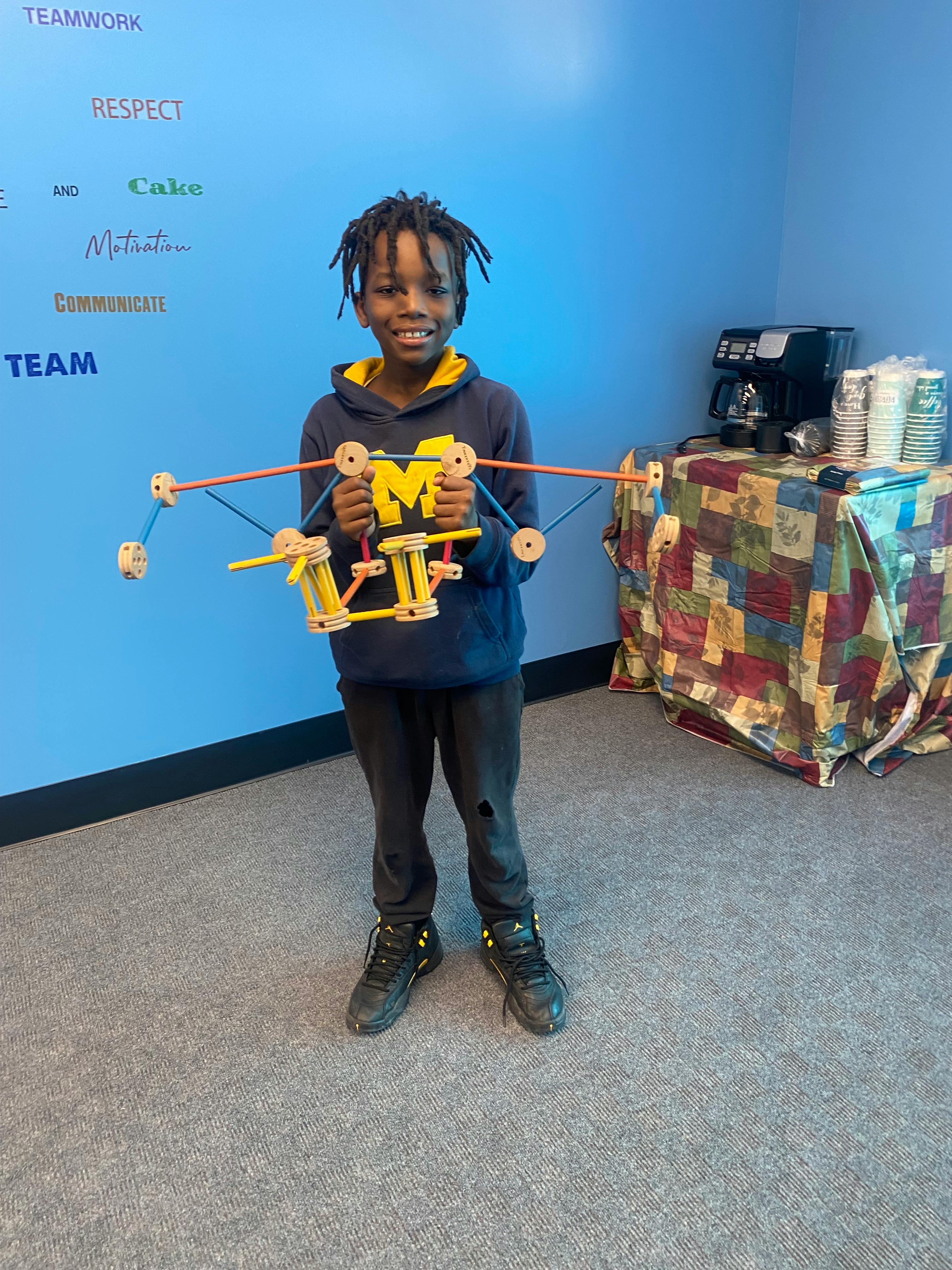 Child holding a wooden toy