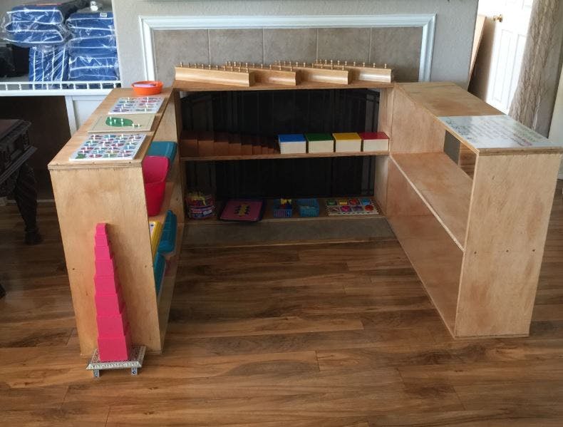 U-shaped wooden shelving unit with various items on shelves