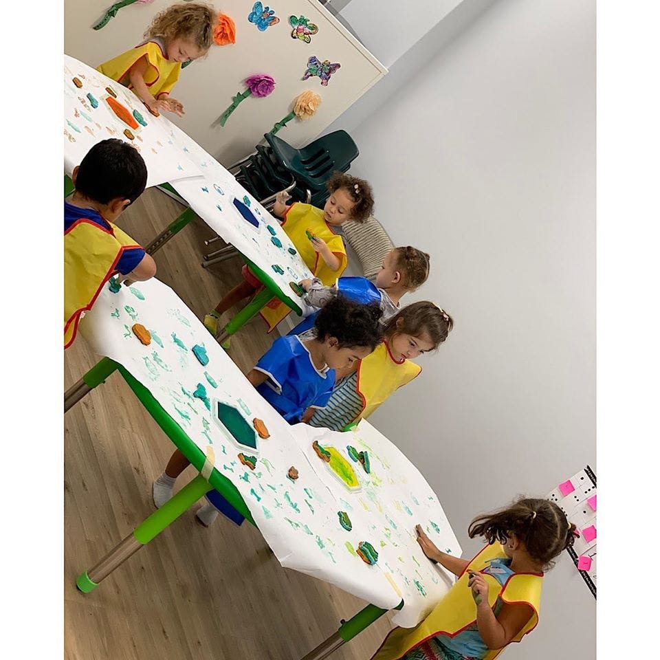 Children painting at a table