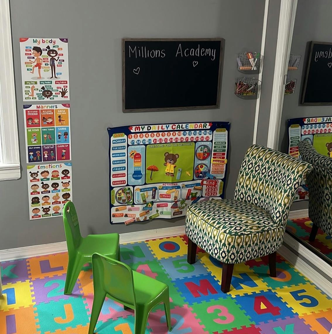 Educational playroom setup with posters, a calendar, and small chairs
