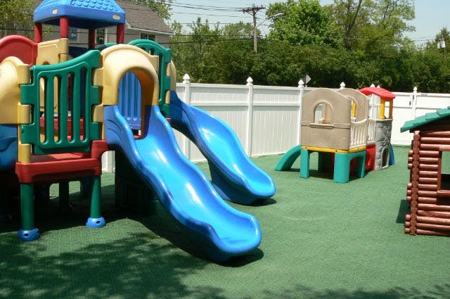 Playground with blue slides and playhouses