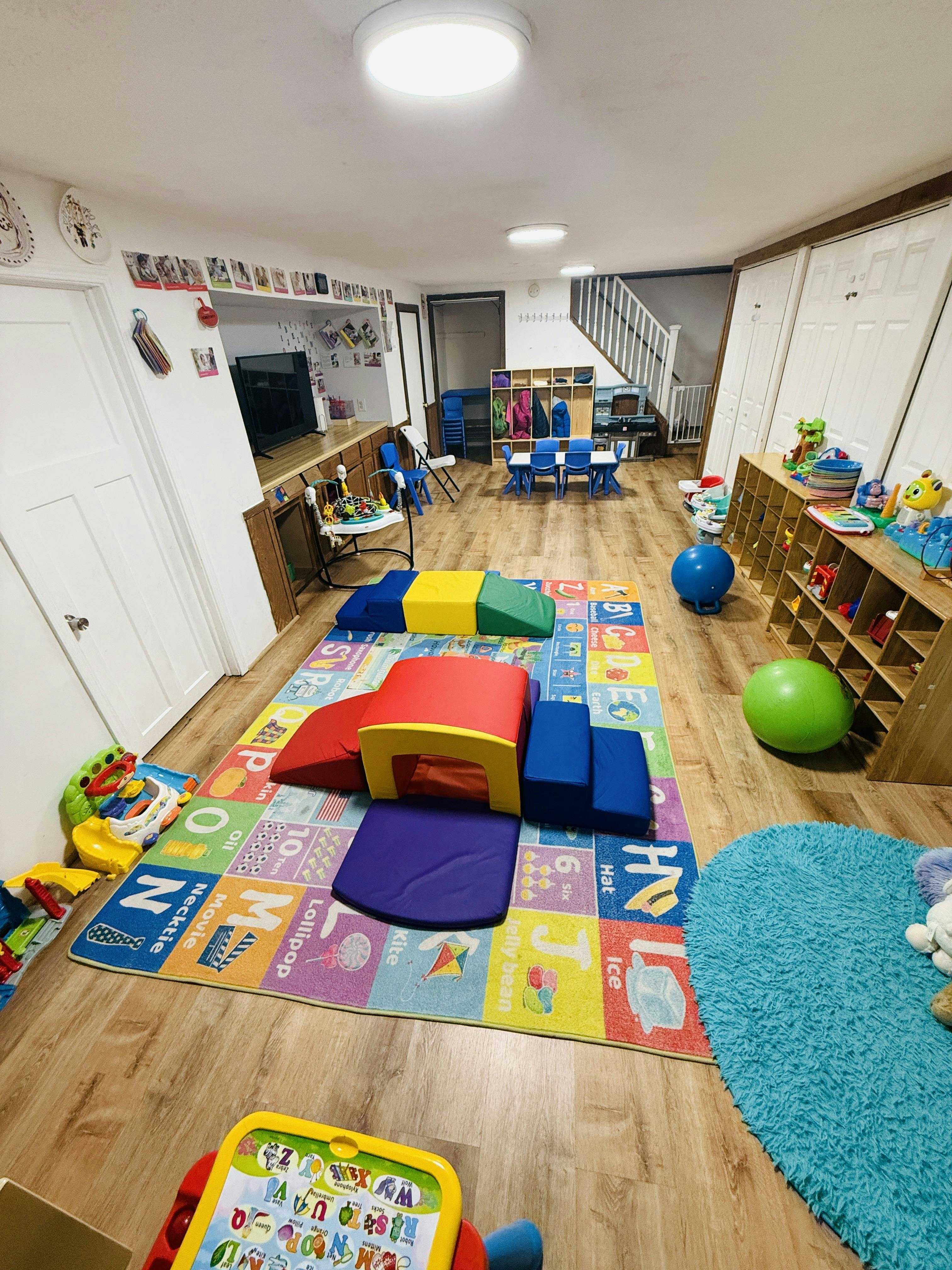 Playroom with soft play shapes on an alphabet rug