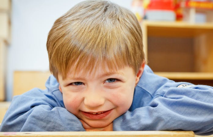 Child resting head on arms