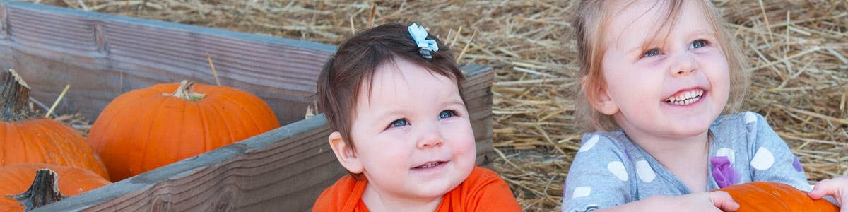 Two children with pumpkins