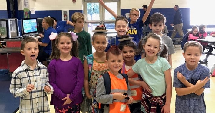 Group of children posing in a classroom