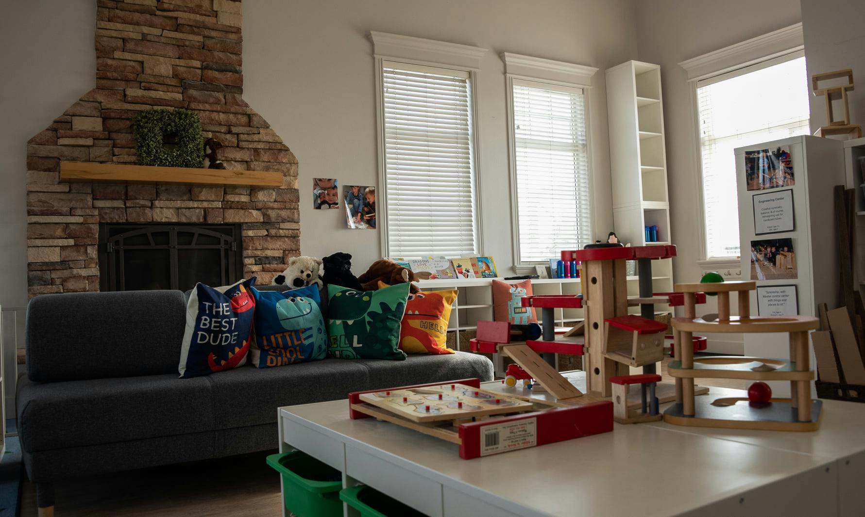 Living room with fireplace, sofa, and children's toys