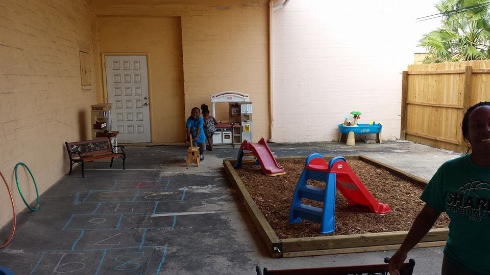 Outdoor play area with slides and sandpit