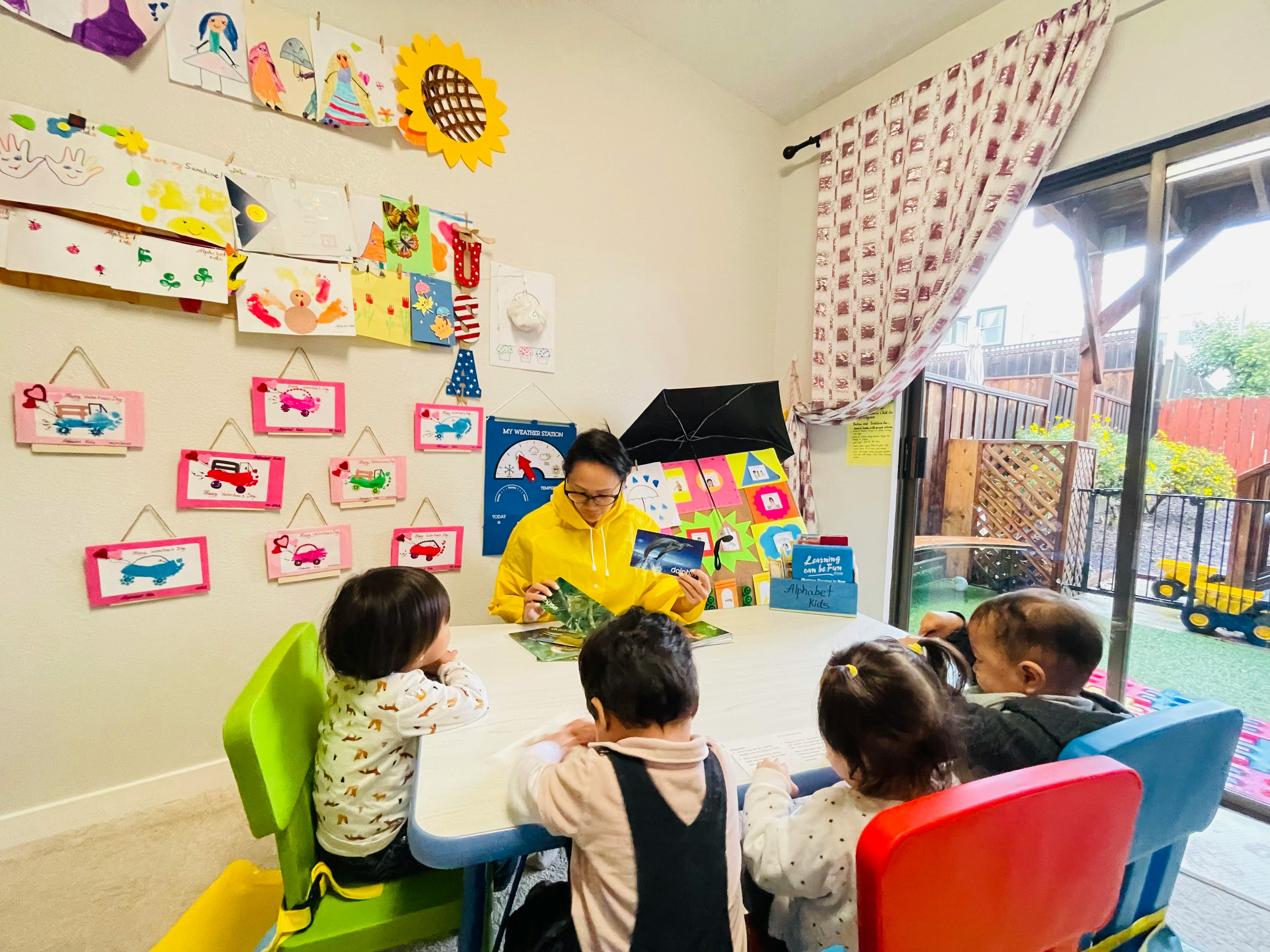 Person reading to children at a table
