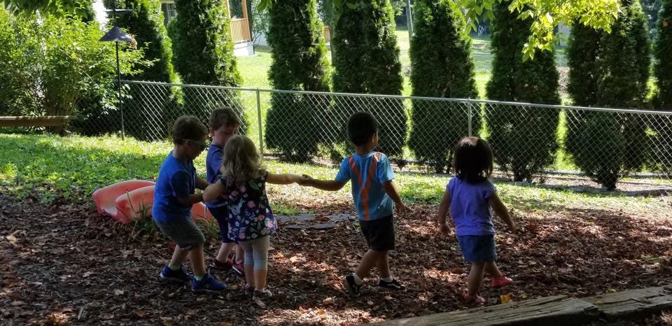 Children playing outdoors on wood chips