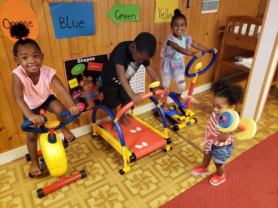 Four children playing with exercise equipment