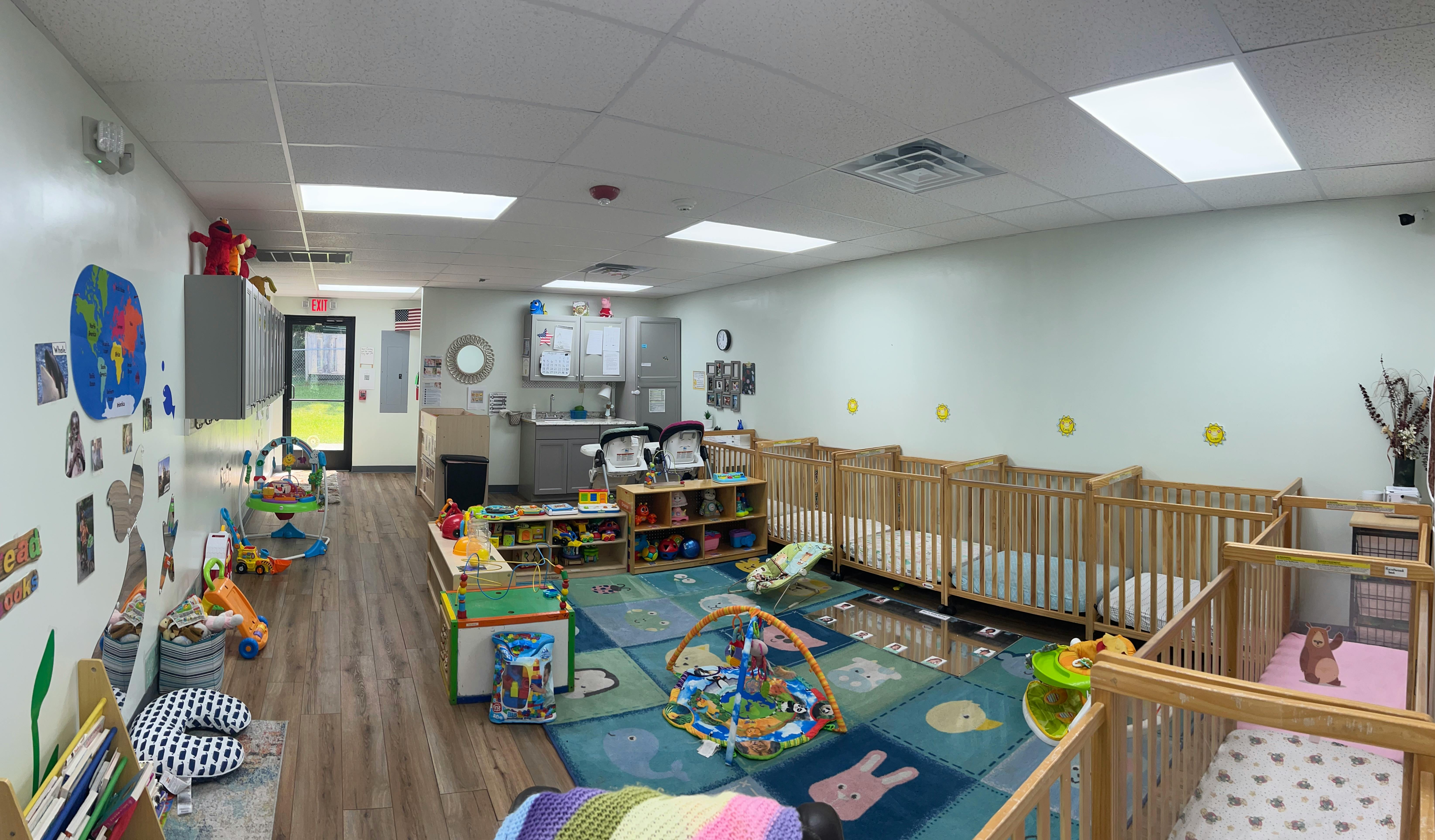 Nursery room with multiple cribs and play areas