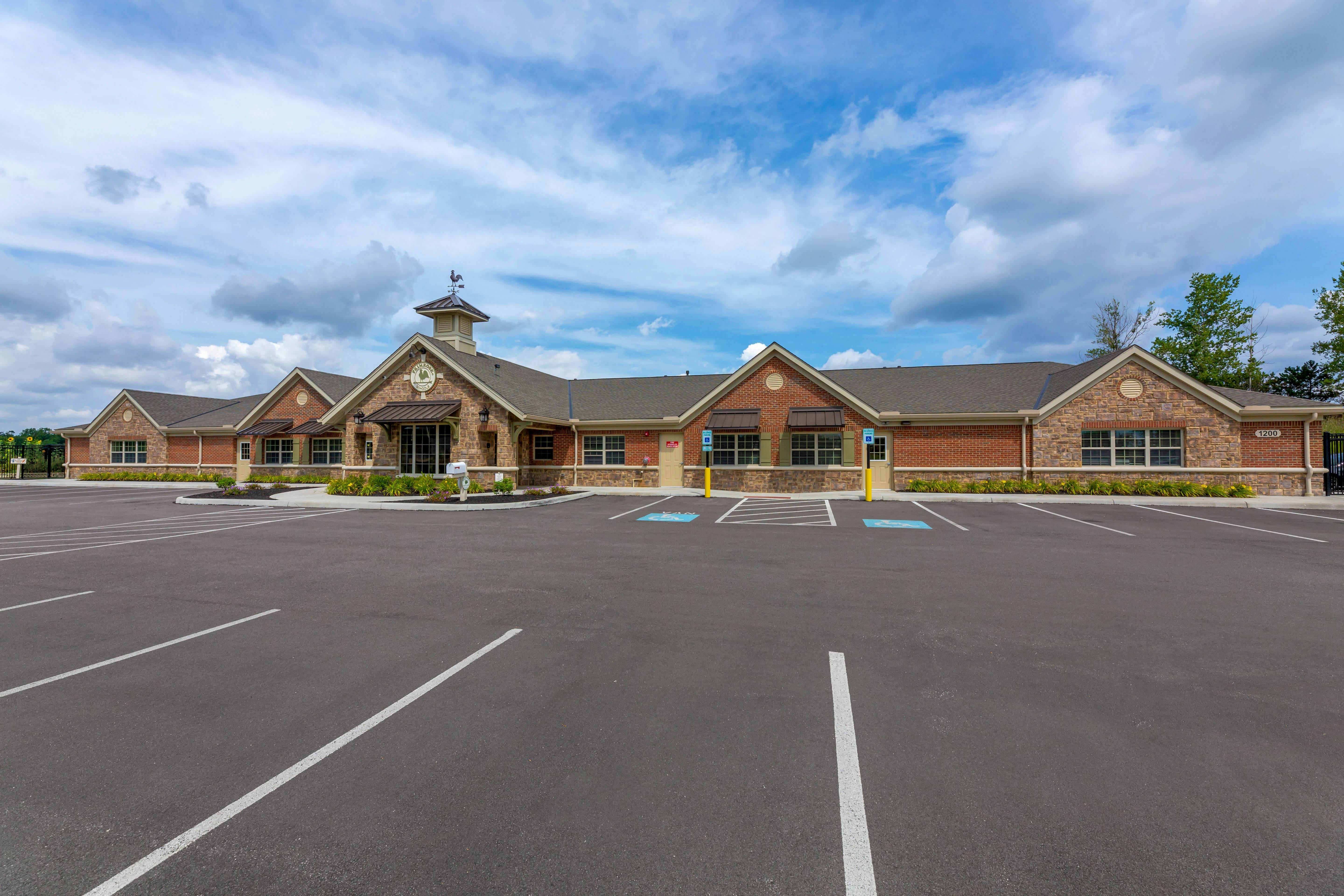 Single story brick and stone building with a parking lot in front