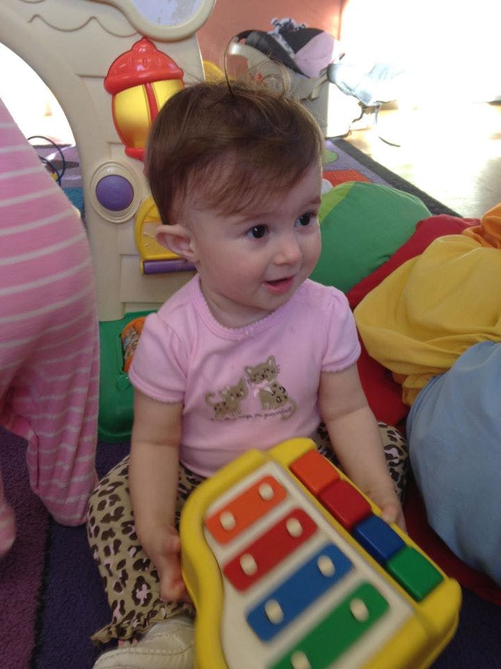 Child holding a toy xylophone
