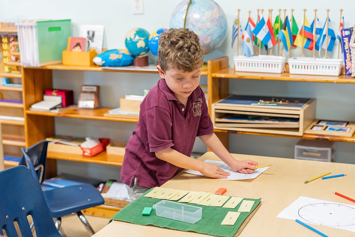 Child working at a table in a classroom