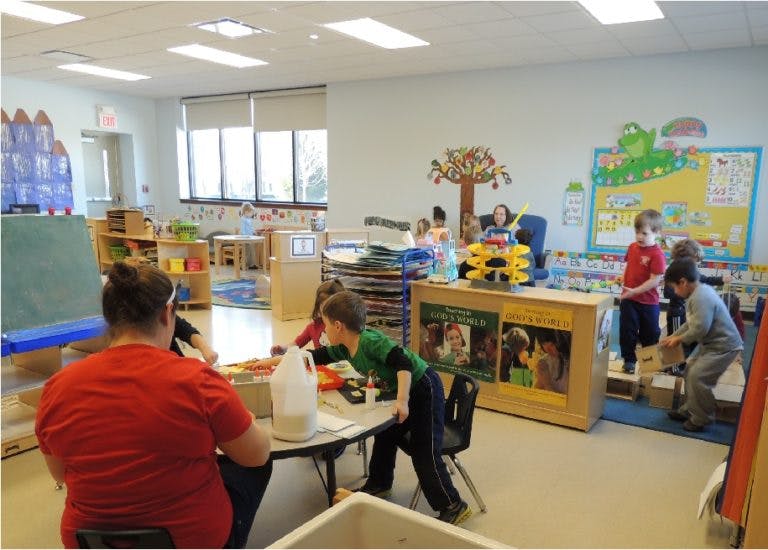 People and children in a classroom